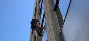 Using rope access to clean high rise windows