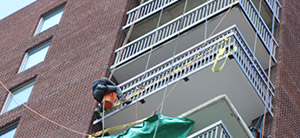 Using rope access to work on a high rise balcony